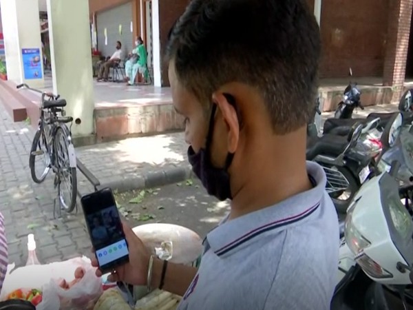 A resident in Chandigarh watching a video on Tik Tok (Photo/ANI)