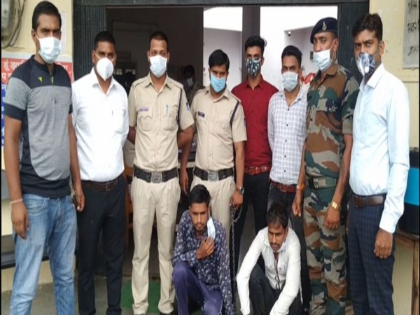 Police officers with the two accused in Shajapur. 