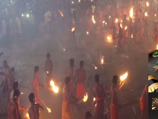 Devotees from Athoor and Kodathoor villages throw fire torches at each other. Photo/ANI