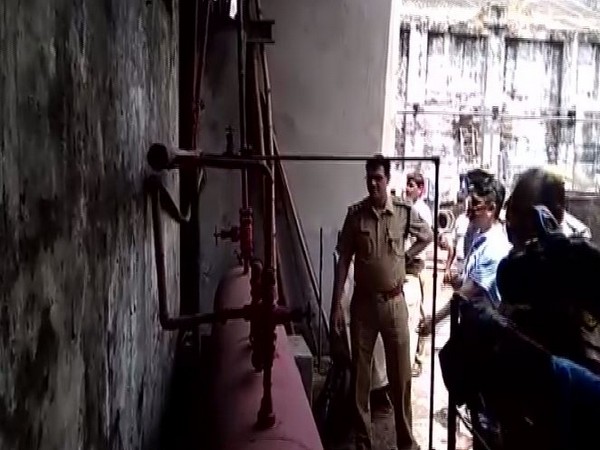 Uttar Pradesh police inspecting the oil mill after the pipe burst on Tuesday. Photo/ANI