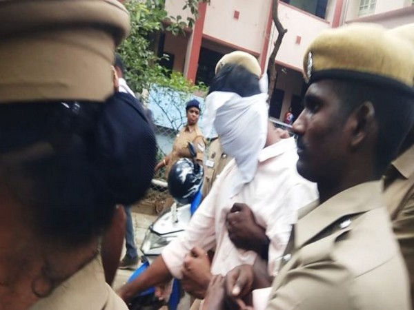 The prime accused with police personnel in Coimbatore on Friday (Photo/ANI)