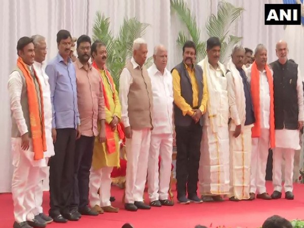 Karnataka Chief Minister BS Yediyurappa and Governor Vajubhai Vala with the ten newly-inducted Cabinet Ministers at Raj Bhawan in Bengaluru (Photo/ANI)