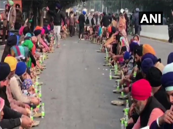 People have 'langar' on road during a protest over Nankana Sahib attack in New Delhi on Saturday.