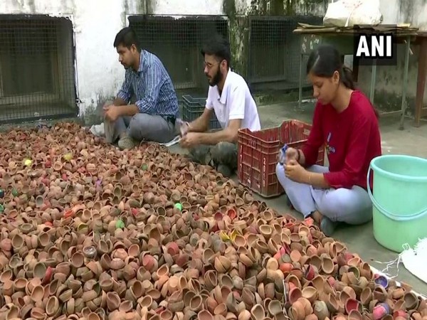 The youth welfare association are cleaning the lamps and will sell them in the market in Chandigarh. Photo/ANI