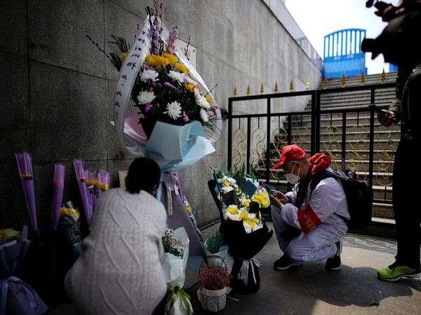 People pay tribute to the deceased in Wuhan who died of the coronavirus disease on the Qingming tomb-sweeping festival, observed on April 4