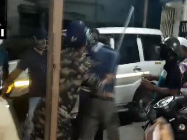 Police using baton to disperse the BJP and TMC supporters in Howrah.