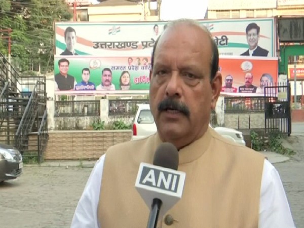 Cong leader Lal Chand Sharma speaking to ANI in Dehradun. Photo/ANI