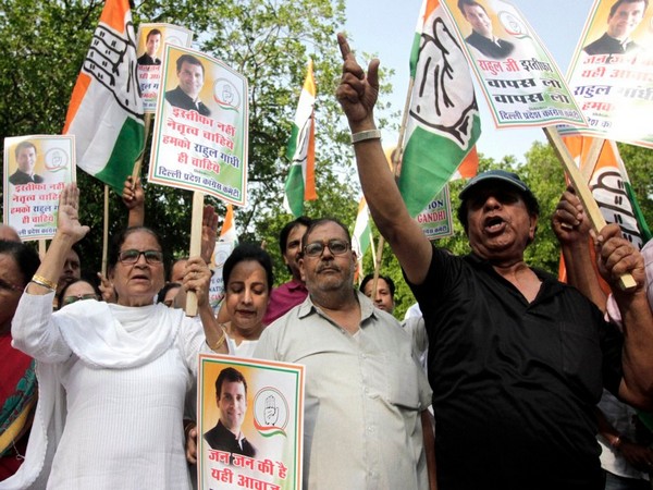 Congress supporters hold placards during a protest outside party president Rahul Gandhi residence at Tughlak lane in New Delhi on Wednesday.