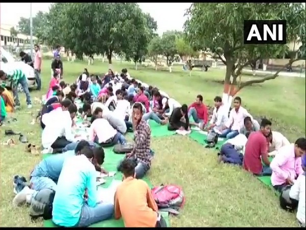 The absence of an examination hall has forced the students to write their examinations in the open at RLSY College, Bettiah.