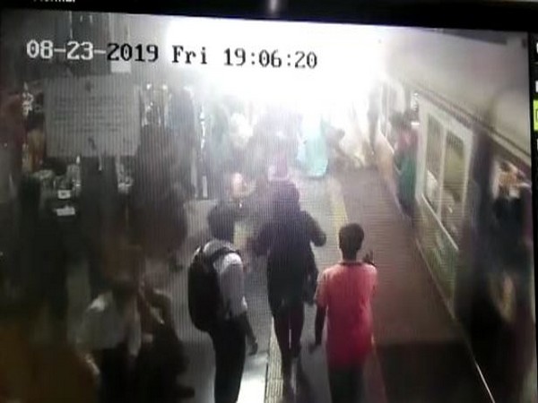 A woman fell down while boarding a moving train; she was rescued by an RPF Jawan. Photo/ANI