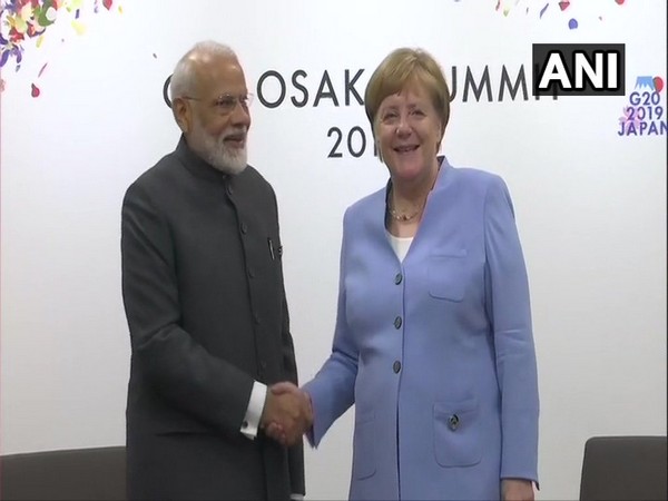 Prime Minister Narendra Modi shaking hands with German Chancellor Angela Merkel on Friday 