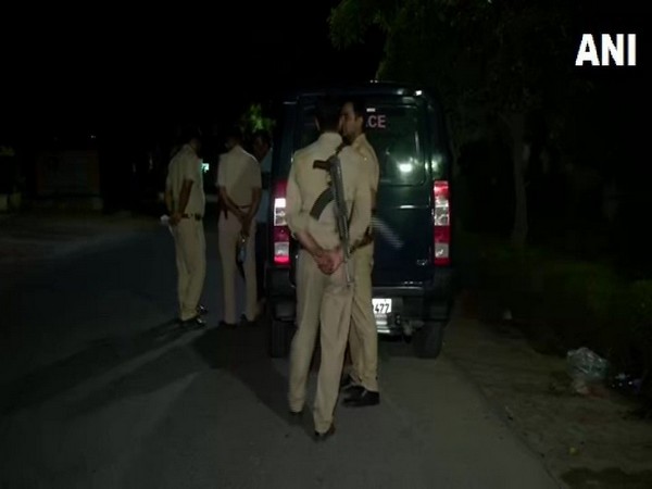 Uttar Pradesh police officials standing outside the house of late Kuldeep Kaur in Noida sector 33 [Photo/ANI]