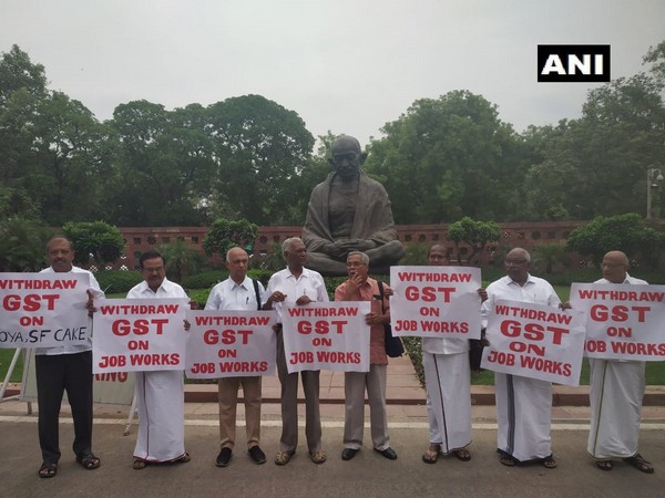 Left party workers hold protest in front of Mahatma Gandhi statue at the Parliament demanding withdrawal of GST on job works 