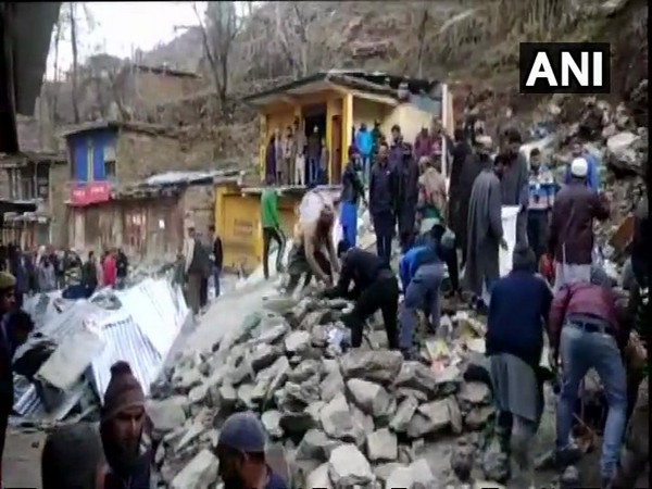 People standing around the structures damaged by landslide in Doda on Wednesday. (Photo/ANI) 