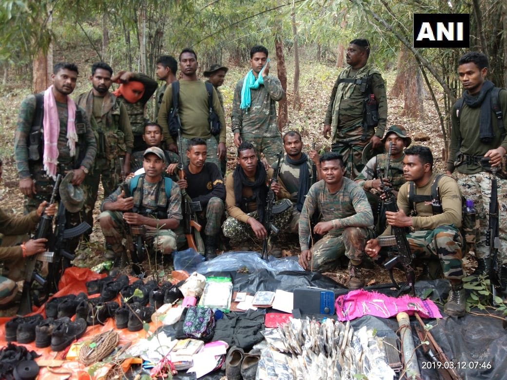 Security forces with seized items fron the Naxal hideout on Wednesdy (Photo/ANI)
