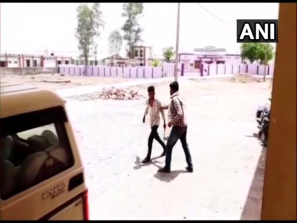 A man spotted with with a hatchet outside the Block Office of Damoh on Thursday. [Photo/ANI]