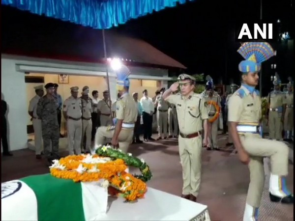 Security personnel and officers pay floral tribute to Sunil Kalita at Guwahati airport