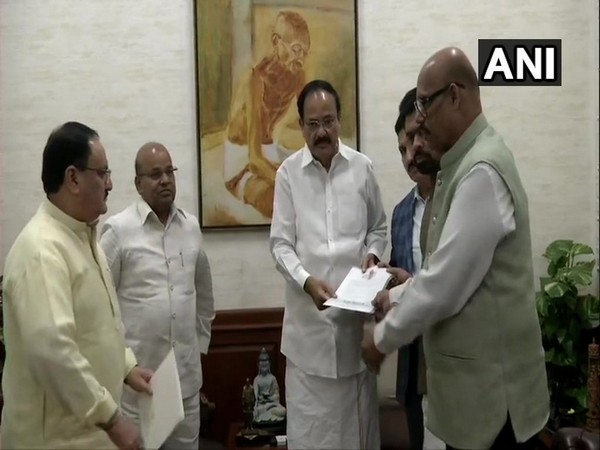The defected MPs with Rajya Sabha Chairman Venkaiah Naidu on Thursday. (Photo/ANI)