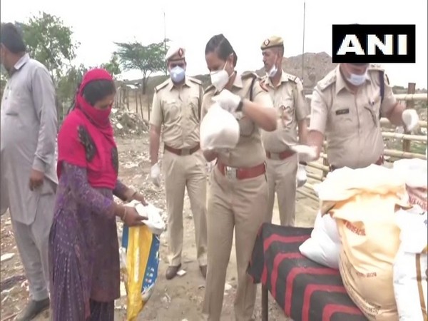 Visual of Vijayanta Arya providing essential commodities to a woman in Majlis Park, New Delhi.