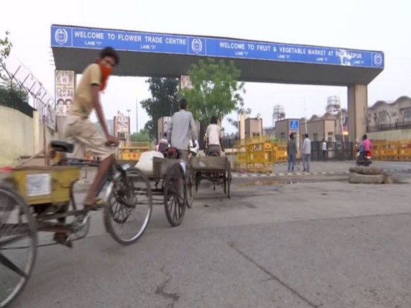 People arrive at Delhi's Gazipur market to buy essentials amid #Unlock1. (Photo/ANI)