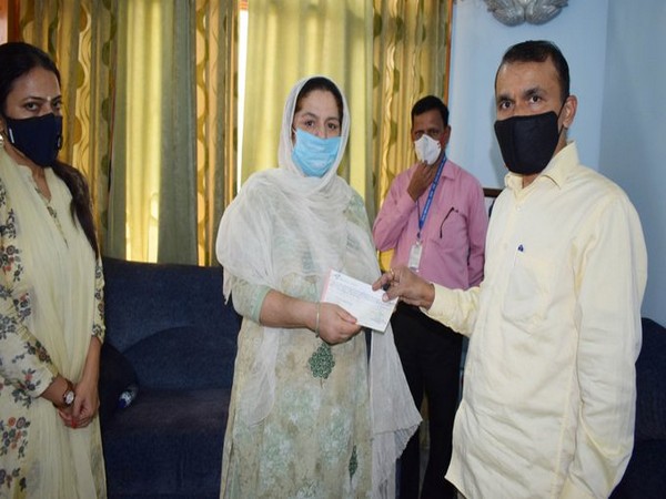 PS to Jammu and Kashmir Lieutenant Governor Nitishwar Kumar handed cheque to family  of slain BDC (Picture credits: DIPR J-K Twitter)