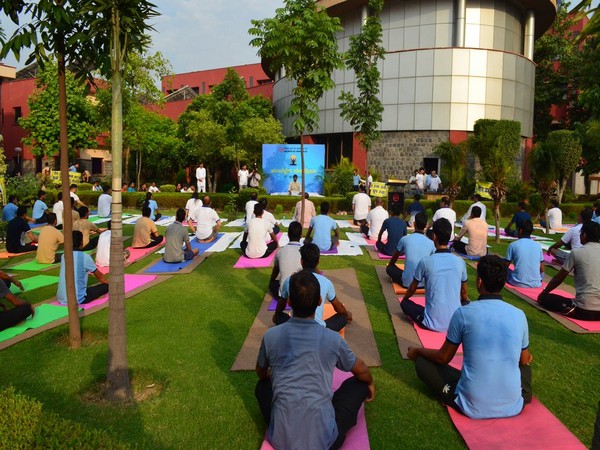 DMRC staff and employees performing yoga on the occasion of 5th International Yoga at Shastri Park metro depot in New Delhi on Friday. (Picture Credits: DMRC Twitter)