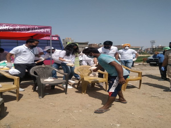 Members of DSLSA distributing food among needy in New Delhi on Wednesday. Photo/ANI