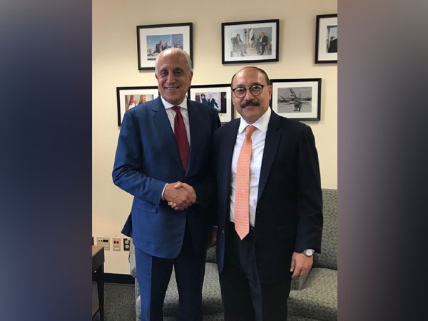 US special peace envoy Zalmay Khalilzad shakes hands with India Ambassador to US Harsh Vardhan Shringla 