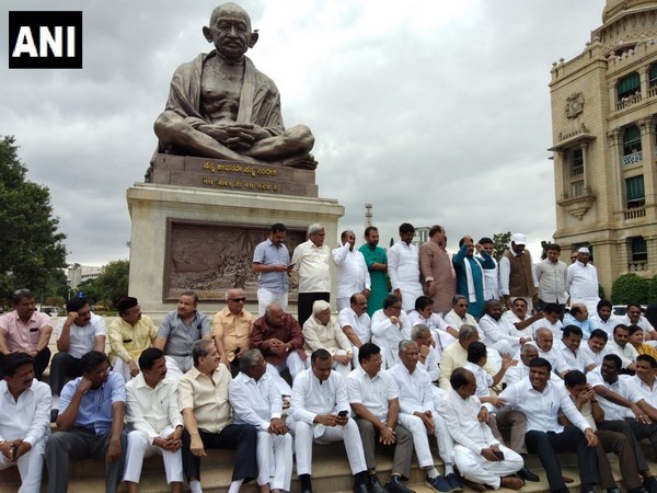 Congress MLAs protesting in front of the Gandhi statue in Vidhan Soudha against the BJP [Photo/ANI]