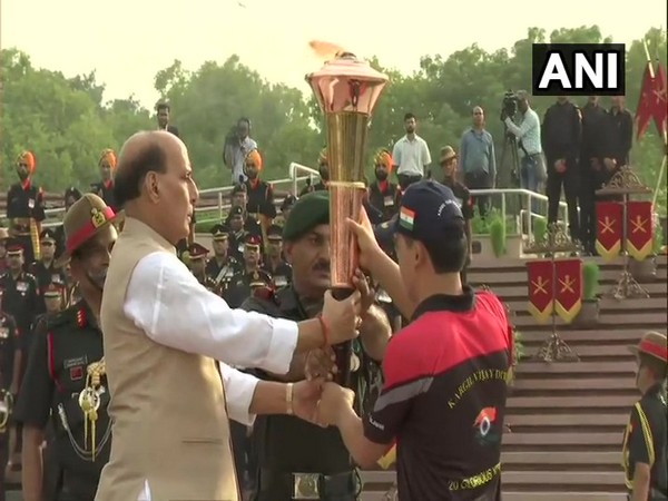 Defence Minister Rajnath Singh holding the 'Victory Flame' on Sunday.