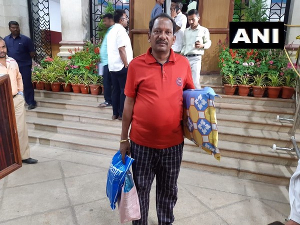 BJP legislator Prabhu Chauhan seen coming with a bed and pillow for the protest in the Vidhana Soudha