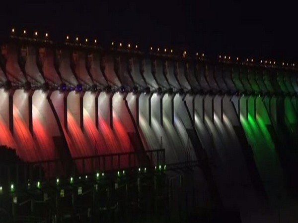 Sardar Sarovar dam lit with bright colour on Monday night. (Photo/ANI)