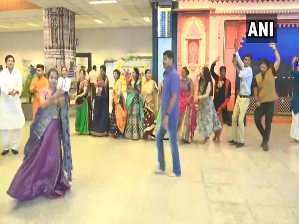 Staff and passengers perfom Garba at the Ahmedabad airport. Photo/ANI