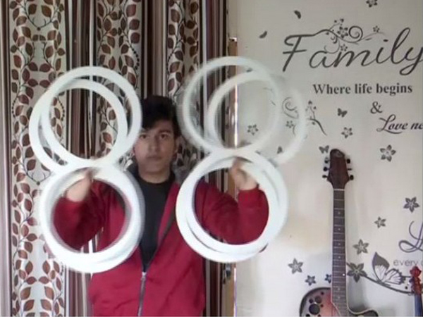 Ashish Kandwal performing ring illusion at his home in Dehradun, Uttarakhand, on Sunday. Photo/ANI