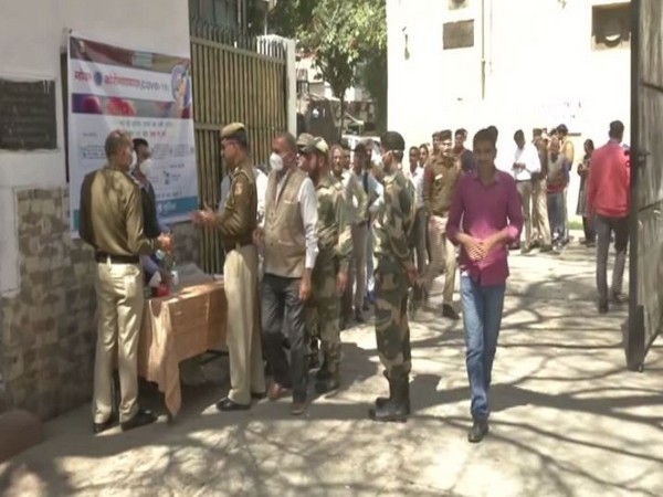 Thermal screening being conducted at Delhi Police office in New Delhi on Tuesday. Photo/ANI