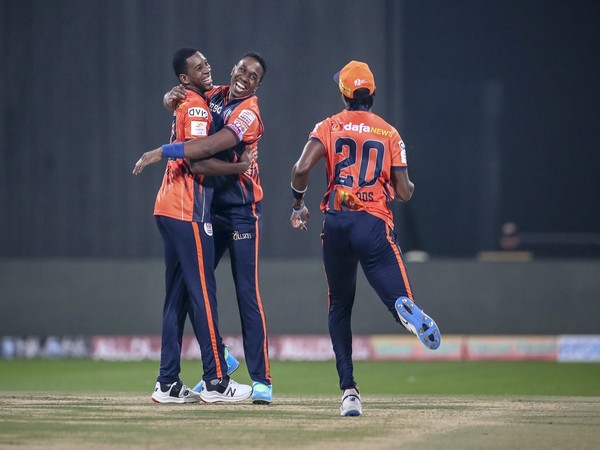 Delhi Bulls players celebrating after taking a wicket. 