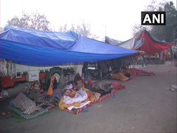 People sleep in tents on Friday morning at Delhi's Singhu border (Photo ANI)