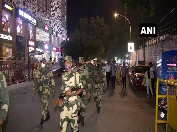 Delhi Police personnel conducted foot patrolling in Sarojini Nagar Market on Tuesday night. Photo/ANI