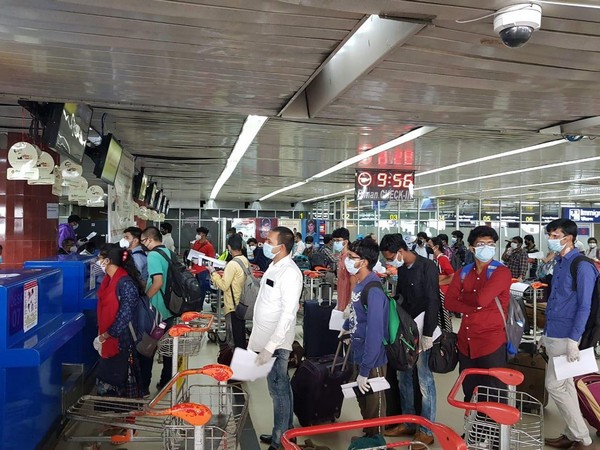 People queue at Dhaka airport to board the special flight to Kolkata on Monday morning.