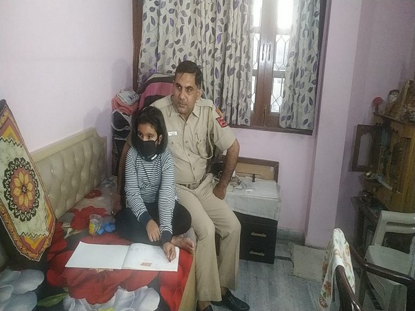 Vidhi, with her father, Delhi Police Head Constable Anil Kumar Dhaka at their residence on Friday. Photo/ANI