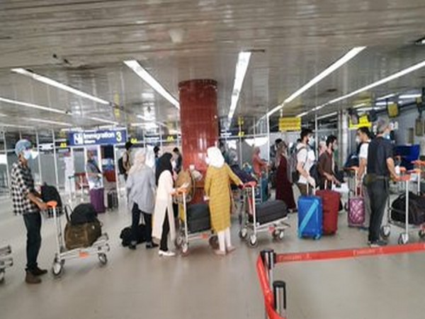 Indian students queue at Dhaka International Airport to board the special Air India repatriation flight to Srinagar today