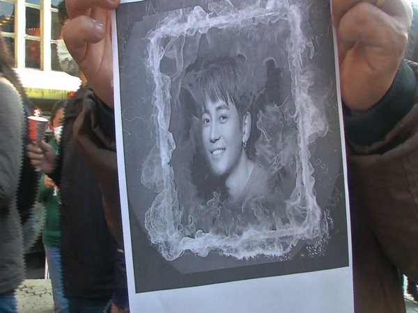A Tibetan holding pictures of Tsewang Norbu (Photo/ANI)