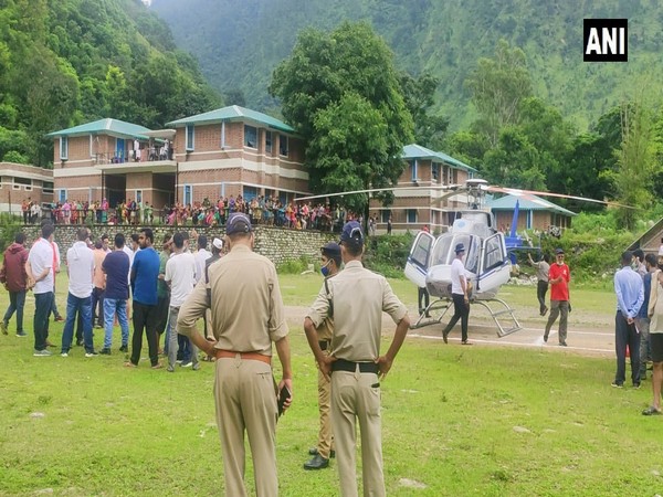An injured woman was rescued by a helicopter in Bangapani village, Pithoragarh district. (Photo/ANI)