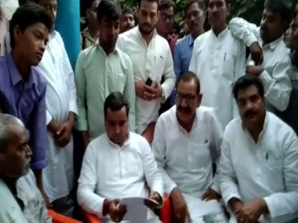 SP leader Dharmendra Yadav with the family members of the deceased in Sunday in Badaun. Photo/ANI