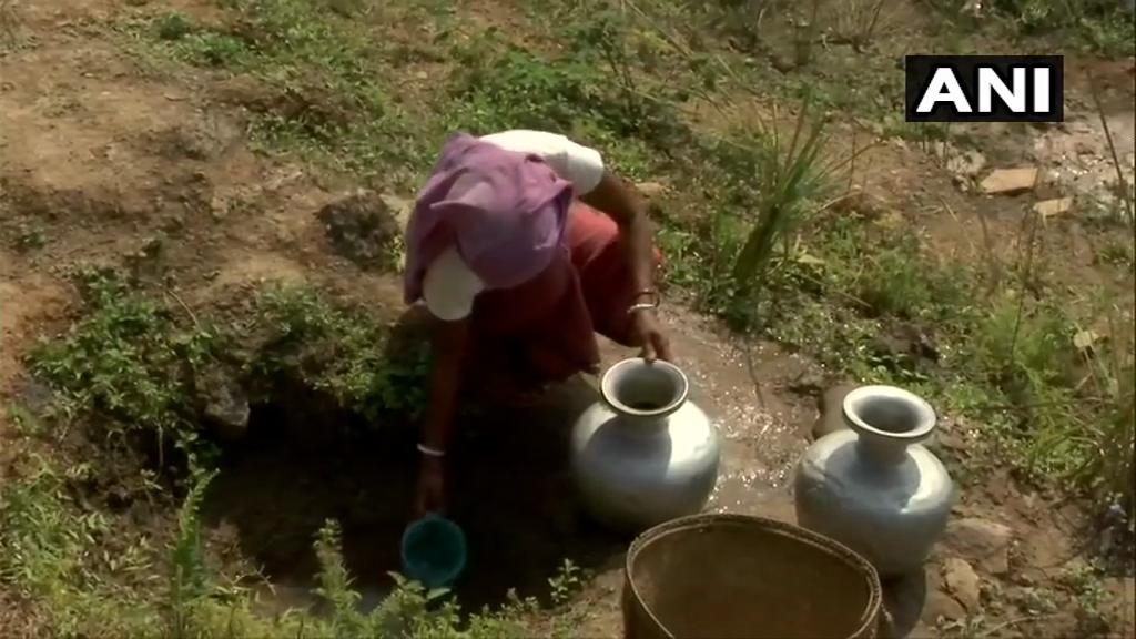 A woman filling their pots with water from a pit in Semidikhor village in Dima Hasao district, Assam.