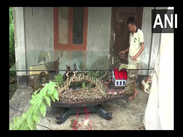 Ningwon Zingkhai, a sculptor carved wooden dining table with panaromic village landscape in Nagaland. (Photo/ANI)