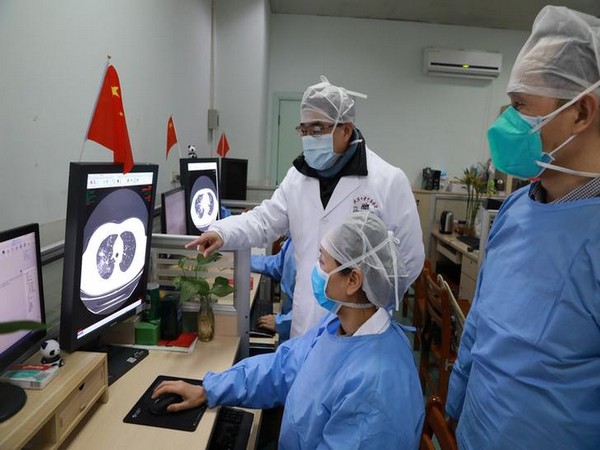 Medical workers inspect the CT scan image of a patient at the Zhongnan Hospital of Wuhan University following an outbreak of the new coronavirus in Wuhan. 