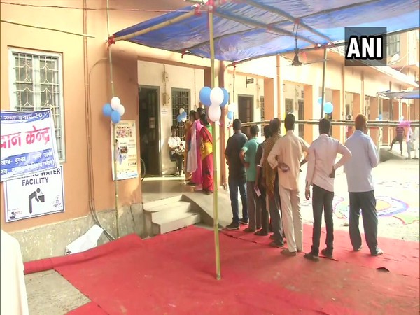 People queue up outside polling station in Dumka, Jharkhand.