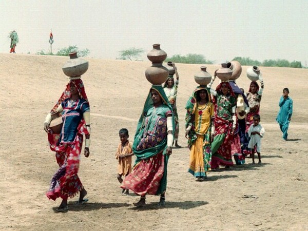  Pakistani women and children carry pots of water on their head. (Photo Credit - Reuters)