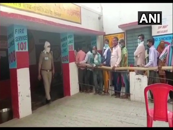 People queue up to cast their votes for the fourth phase of UP Panchayat polls in Sambhal. [Photo/ANI]